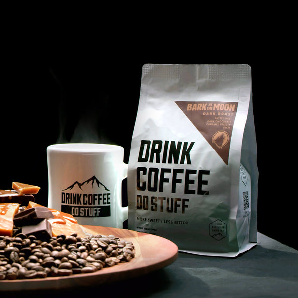 Coffee bag, mug and plate of coffee beans.