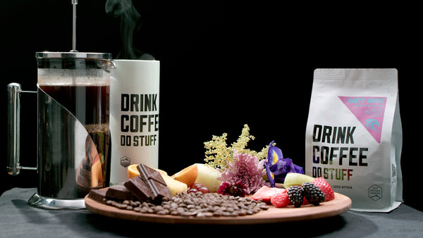 Coffee mug, coffee beans, and coffee packaging on a dark background