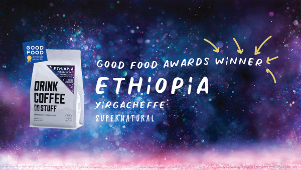 Coffee package with 'Good Food Awards Winner' text on a cosmic background